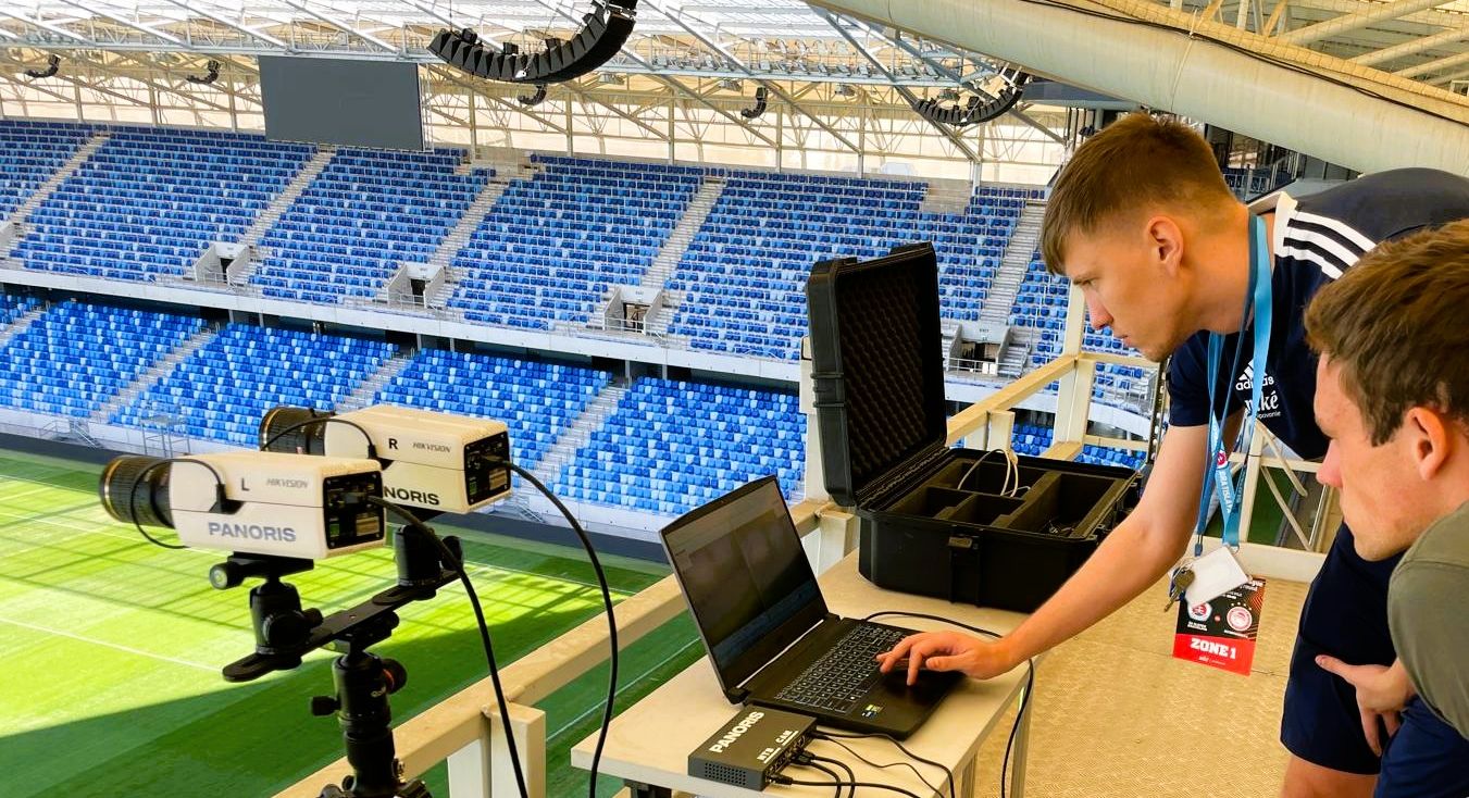 Panoris team collaborating around a laptop with football video on the screen